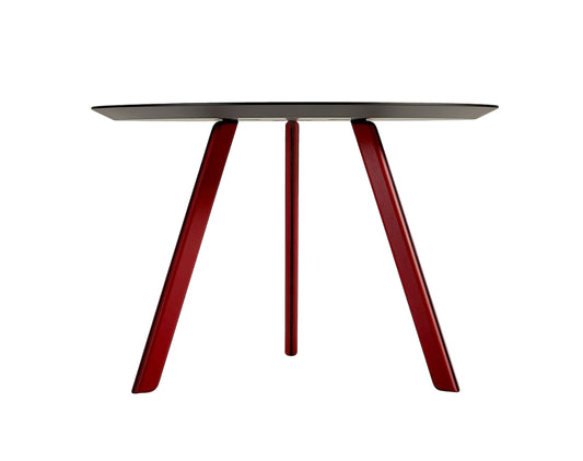 Round table with a black top and red legs on a white background