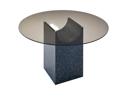 Modern round glass table with a unique base design on a white background